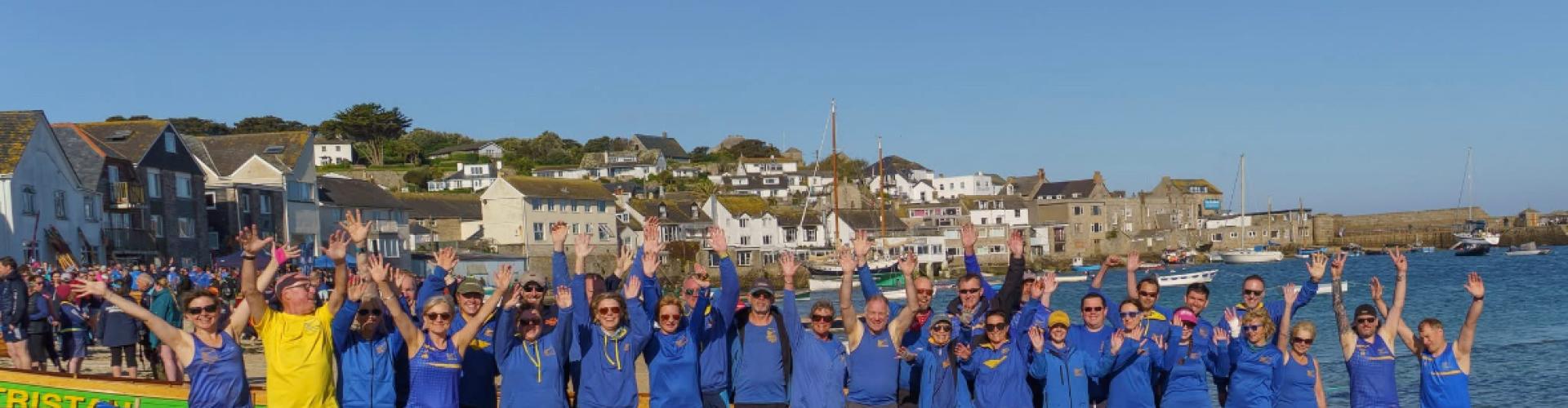 Clevedon Pilot Gig Club stood in front of Blackbird, the gig boat