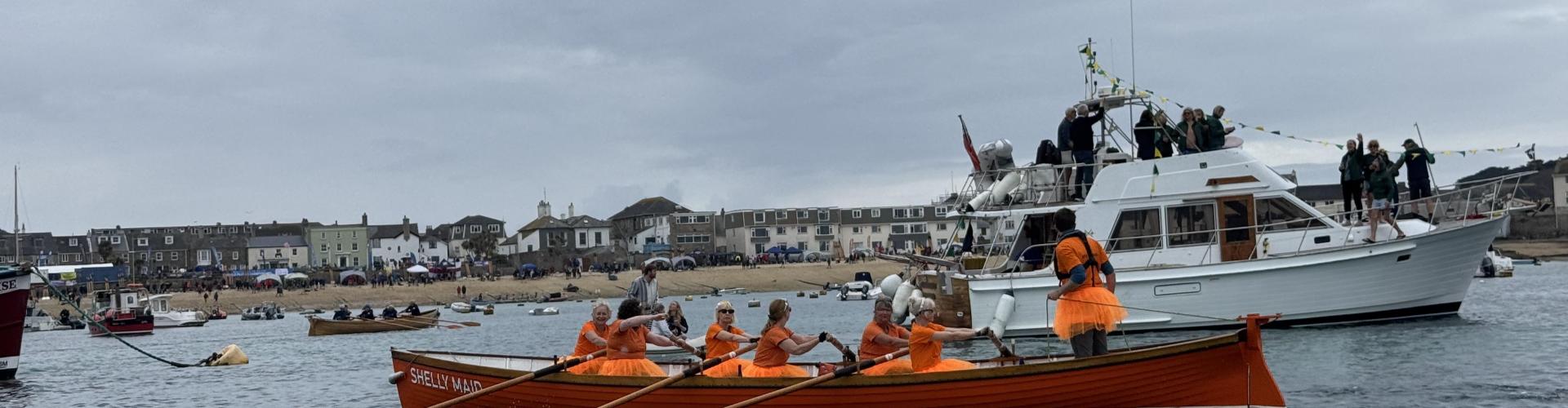 Shelly Maid and the C crew rowing back from the final race, in fancy dress
