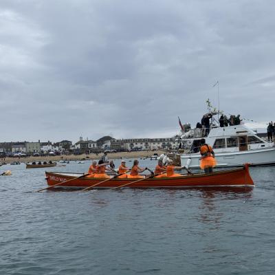 Shelly Maid and the C crew rowing back from the final race, in fancy dress